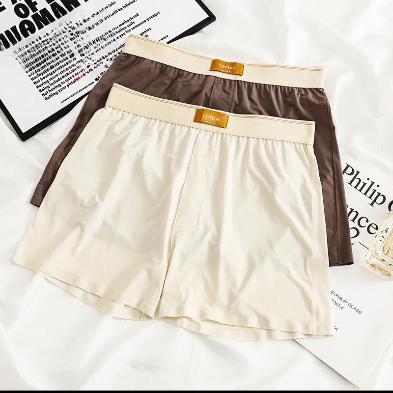Pack of men's solid colour ice silk boxer shorts showing loose fit and mid-waist design.