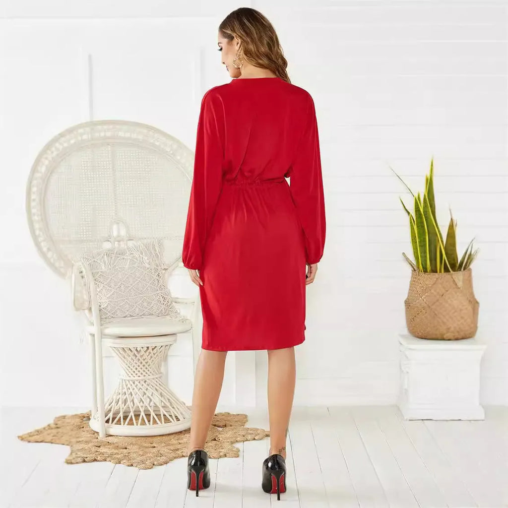 A black women's A-line midi dress with an elastic waist, long sleeves with elastic cuffs, and a detachable cinched belt.