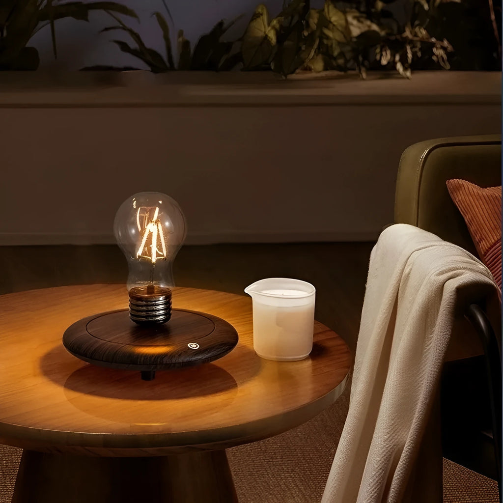 Iron art suspension bulb night lamp on a black wood grain base for desktop decoration.