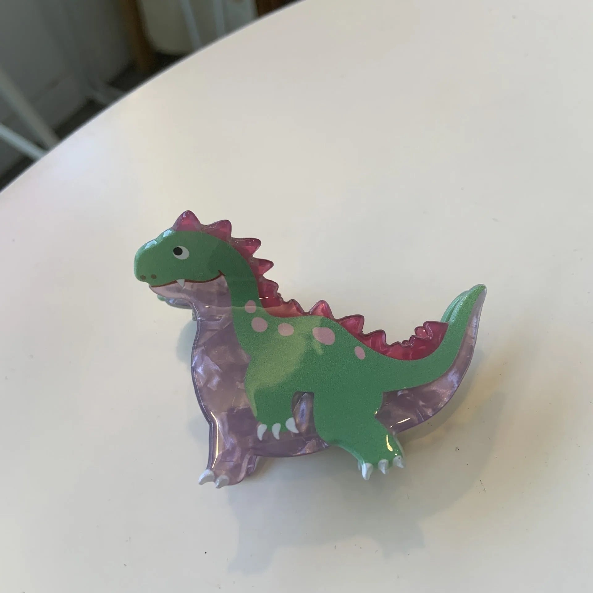Dinosaur-themed acrylic jaw hair clip showing detailed dinosaur design and secure grip mechanism
