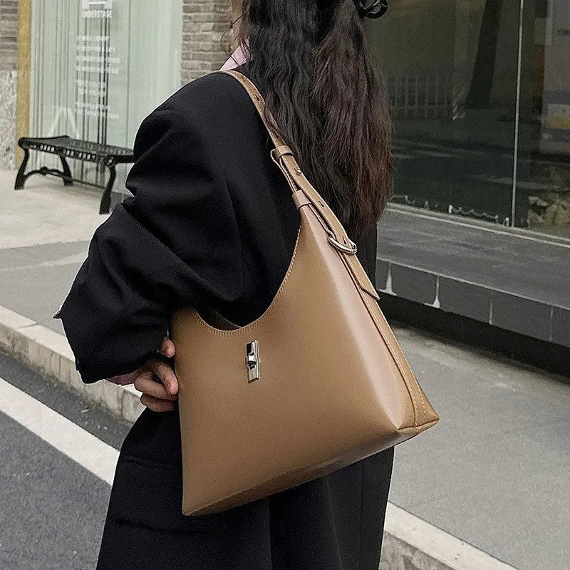 Soft genuine leather dumpling-shaped crossbody shoulder bag in a street style with lock detail