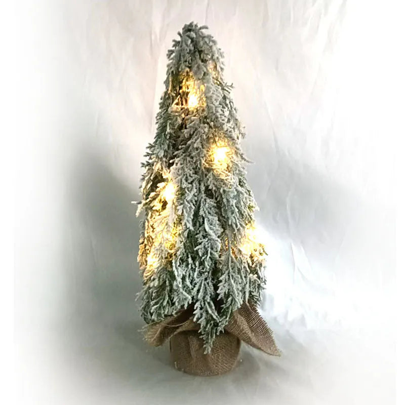 24-inch plastic artificial Christmas tree with snow sprayer and integrated lights on desktop