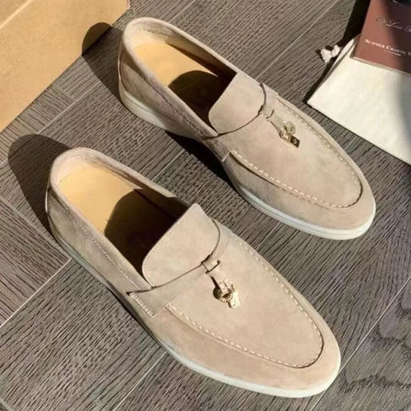 Unisex black slip-on casual loafers with rubber sole and round toe cap on a white background
