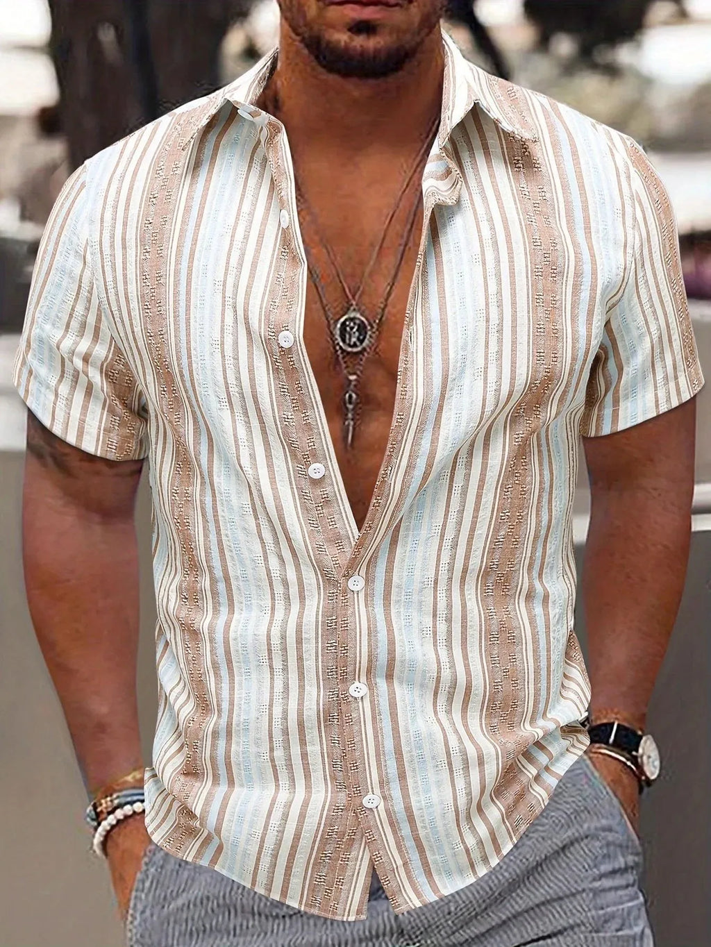 Man wearing a short sleeve striped casual shirt in blue, showing 3D print detail and lightweight fabric.