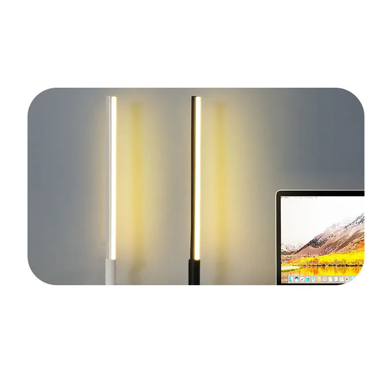 Tall, cylindrical black aluminium alloy retro atmosphere lamp on a table.