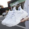 White women's casual mesh sports shoes with a buckle and thick sole.