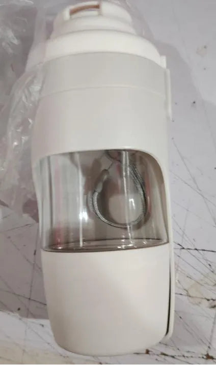 Green portable dog water bottle and feeder with attached lanyard, showing separate food and water compartments.