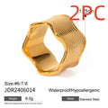 Stainless steel wide band ring with an embossed geometric wave pattern, shown in an electroplated colour.
