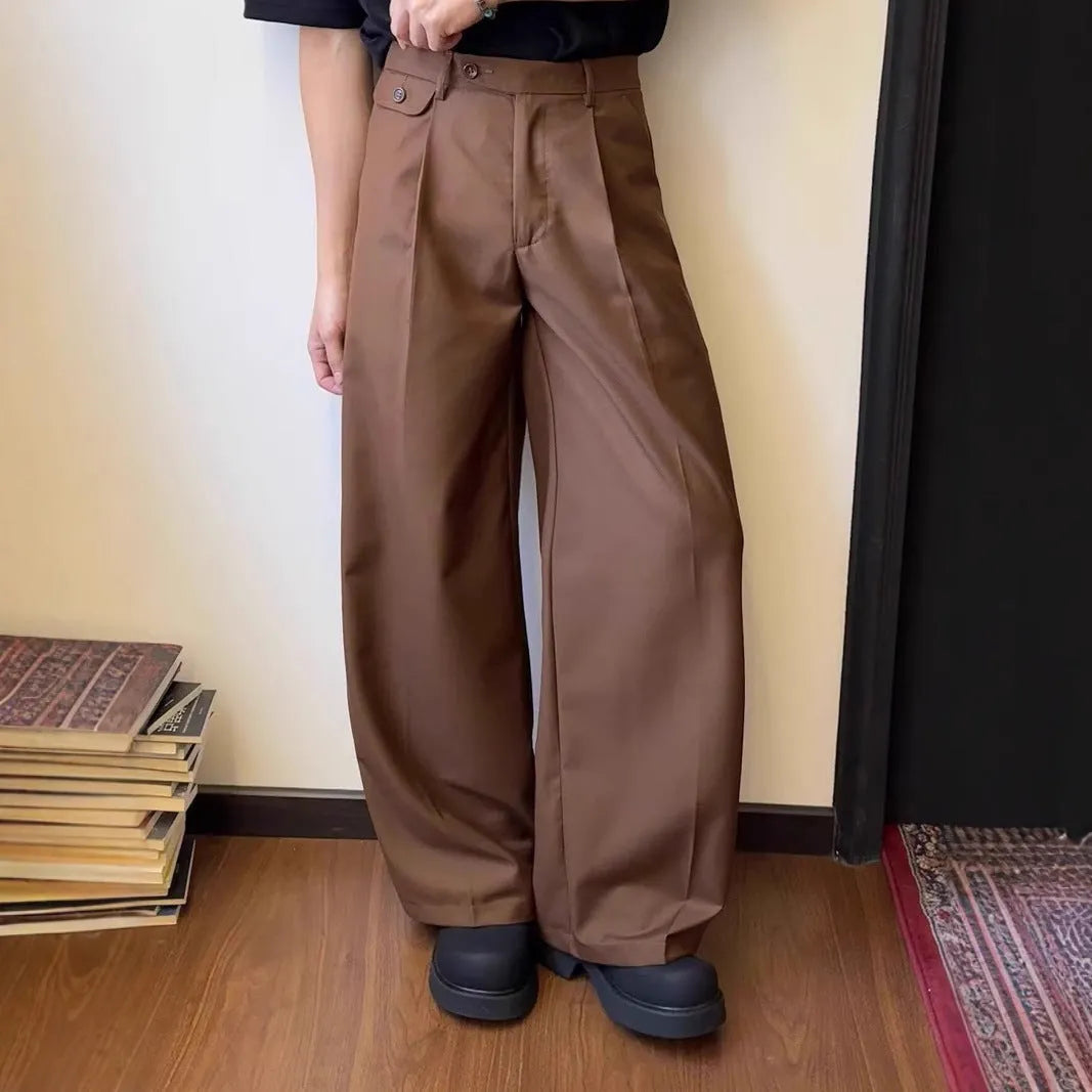 Men's brown straight-leg casual trousers with a loose wide-leg cut on a neutral background.