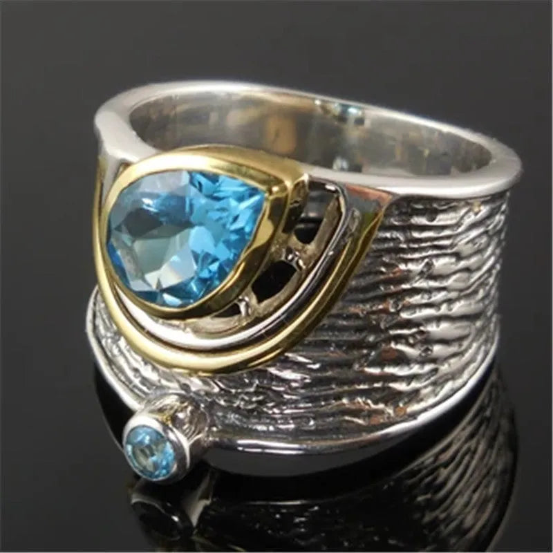 Chinese style blue zircon rhinestone alloy ring in a drop shape on a model's finger.