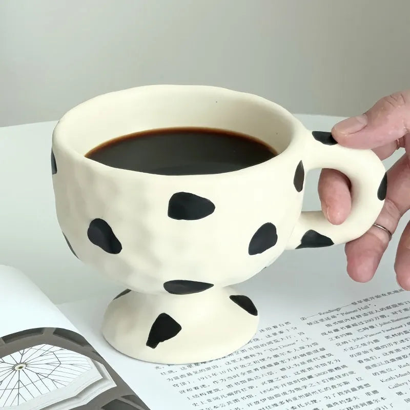 Hand-pinched irregular shaped ceramic mug in a solid colour, modern simple design