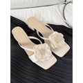 Women's cream white chunky heel sandals with square toe and single satin strap on a rubber sole.