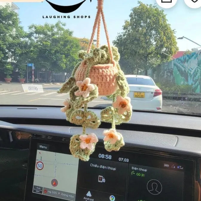 Green and white fish-scale style knitted wool car hanging planter with 8cm base and long white cord.