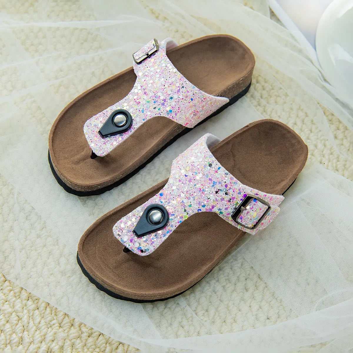 Gold cork flip-flops with a frosted artificial leather upper and a textured PVC sole.