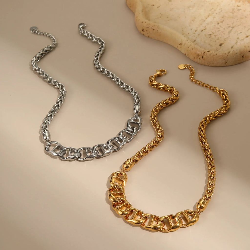 Stainless steel geometric pendant necklace with gold plating on a regular chain.