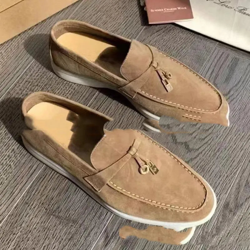 Unisex black slip-on casual loafers with rubber sole and round toe cap on a white background