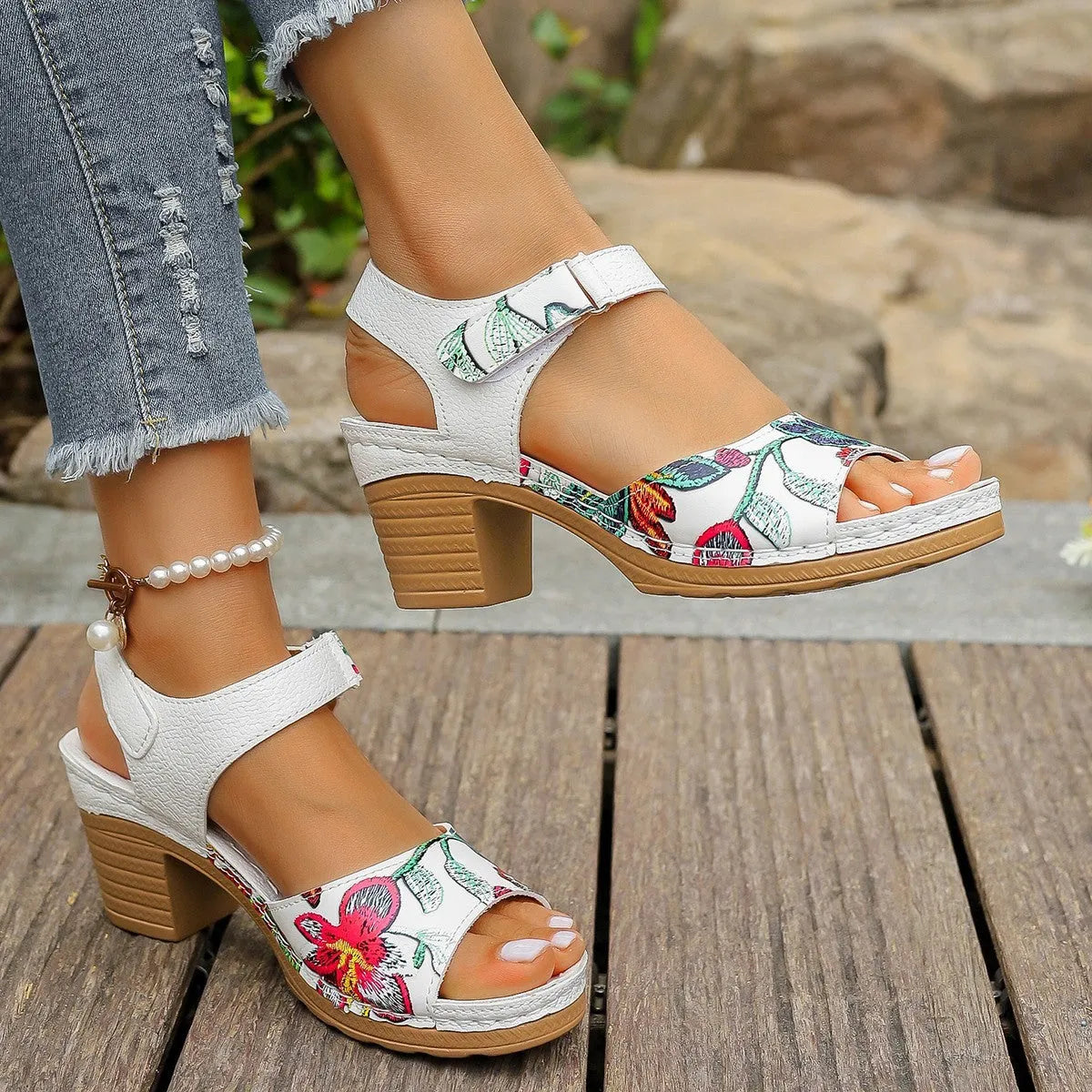 White women's high heel sandals with a Velcro strap closure on a rubber sole.