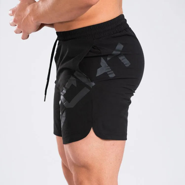 Men's elastic knee-length training shorts in quick-drying chemical blend fabric shown in black colour