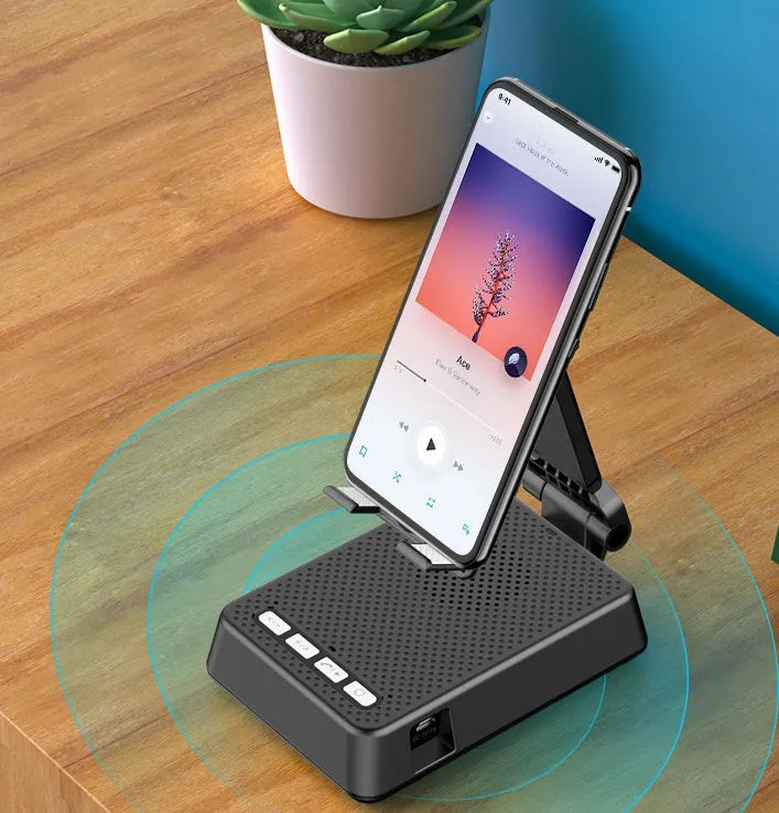 Black mobile phone broadcaster stand with wireless Bluetooth speaker and integrated HD microphone on desk