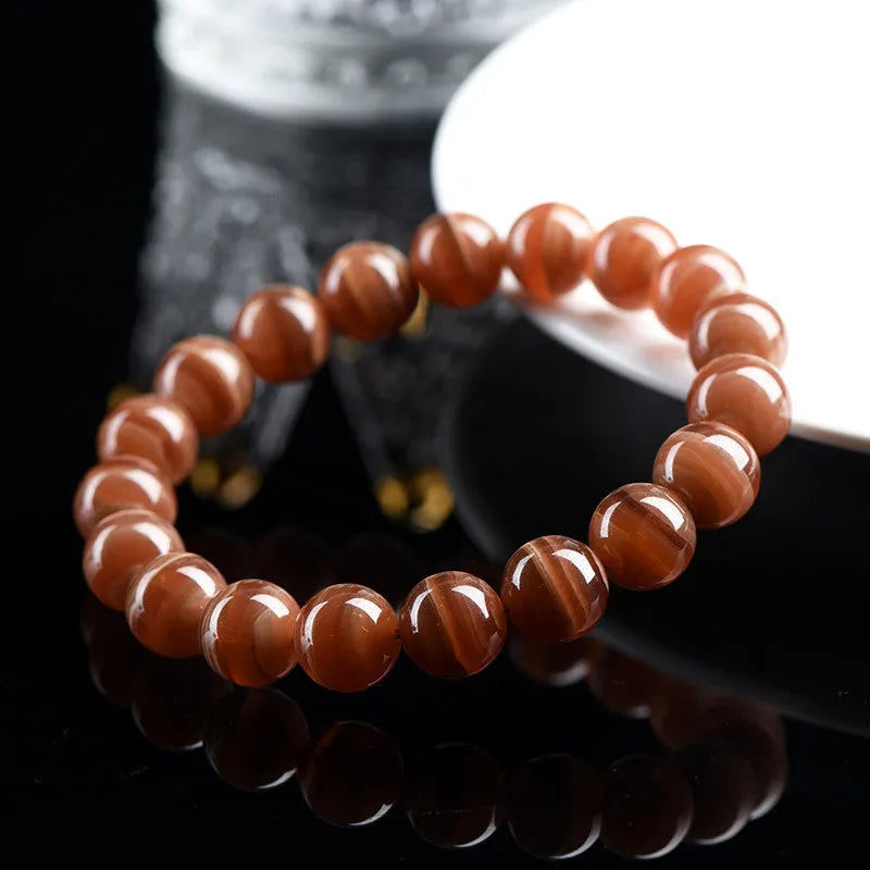 Natural old mine rhodochrosite round bead bracelet with ruyi design element.
