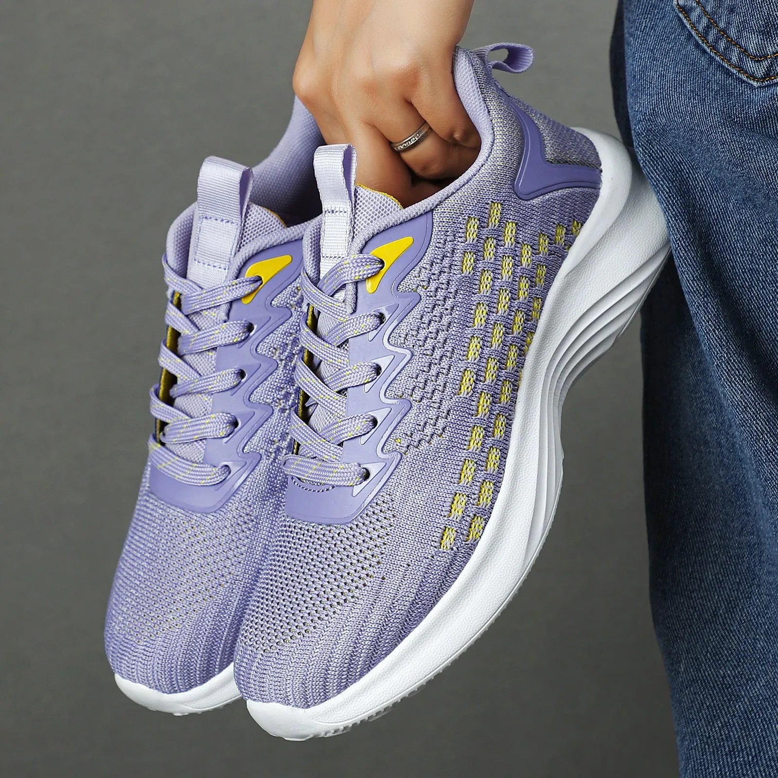 Women's lavender purple Flyknit mesh running shoes with round toe and flat wedge heel on a white background.