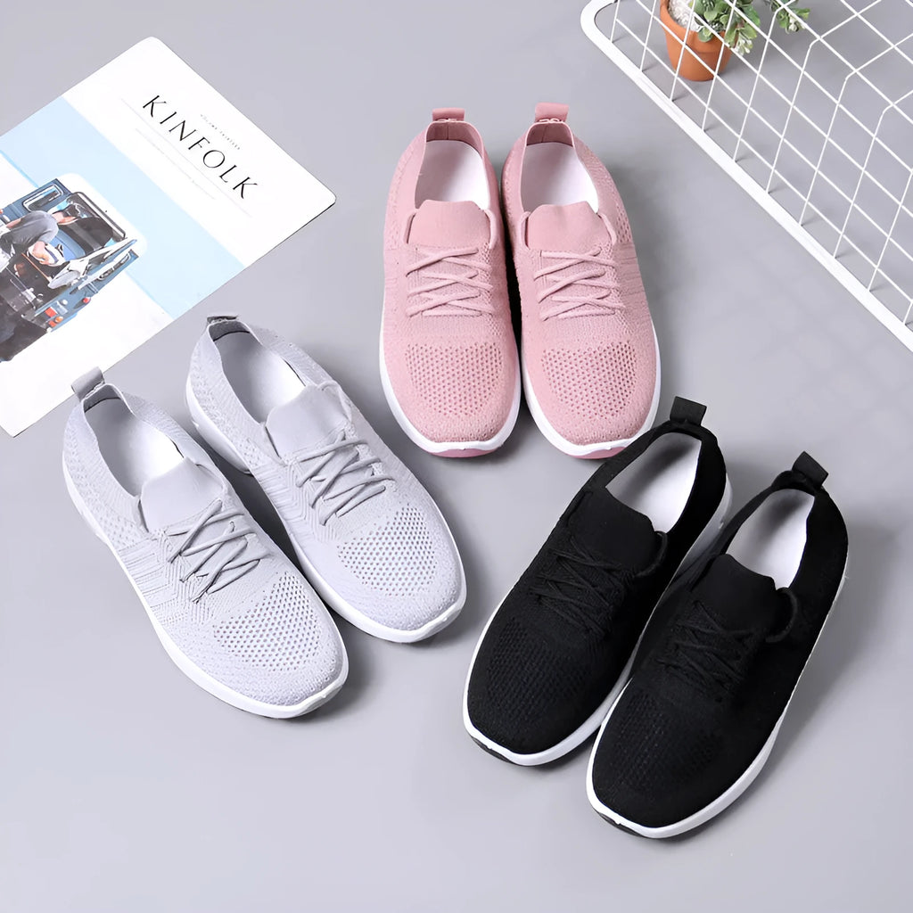 Women's casual mesh sneaker in black with lace-up front and round toe on a soft PVC sole.