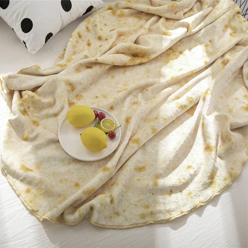 Coral coloured round flannel burrito blanket on a grey background