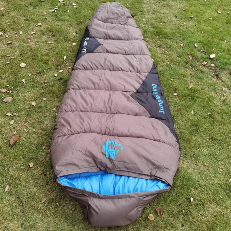 Cotton sleeping bag in Army Green colour compressed inside its storage bag alongside the unfolded sleeping bag.