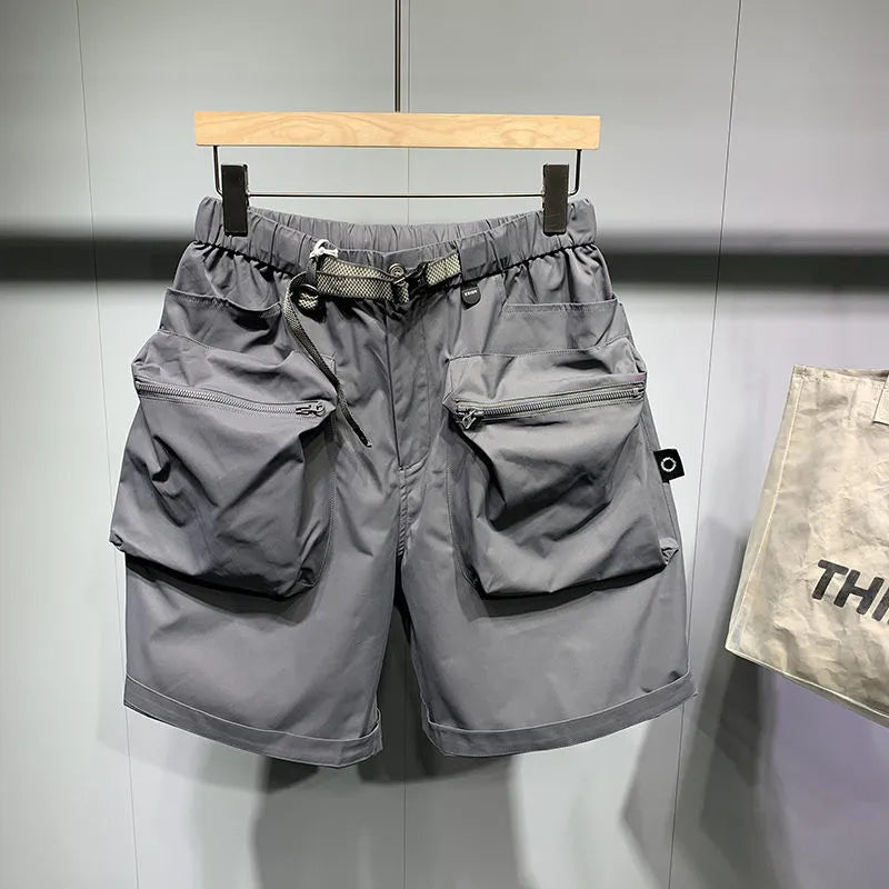 Men's black loose fit work shorts with pockets and straight leg hem above knee length