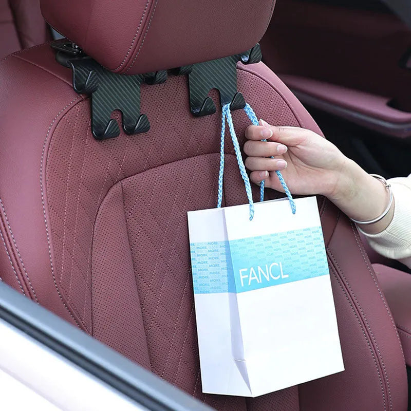 Black ABS plastic car hook with integrated phone holder bracket for rear seat organisation.
