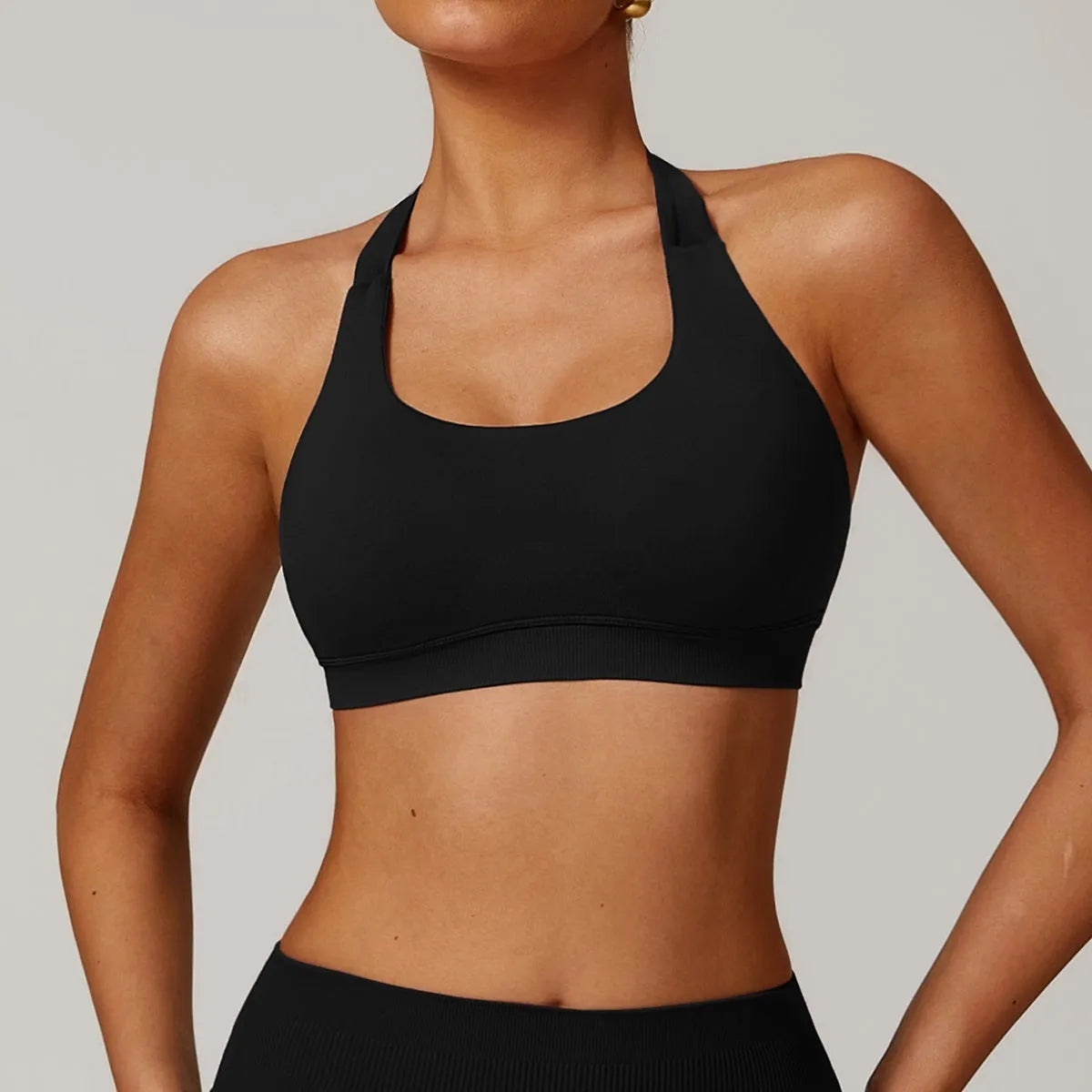 Women's halter neck sports bra in nylon with built-in pads and medium support