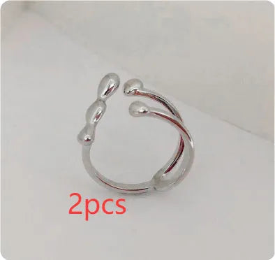 Brass opening ring in gold or silver finish with spherical design details.