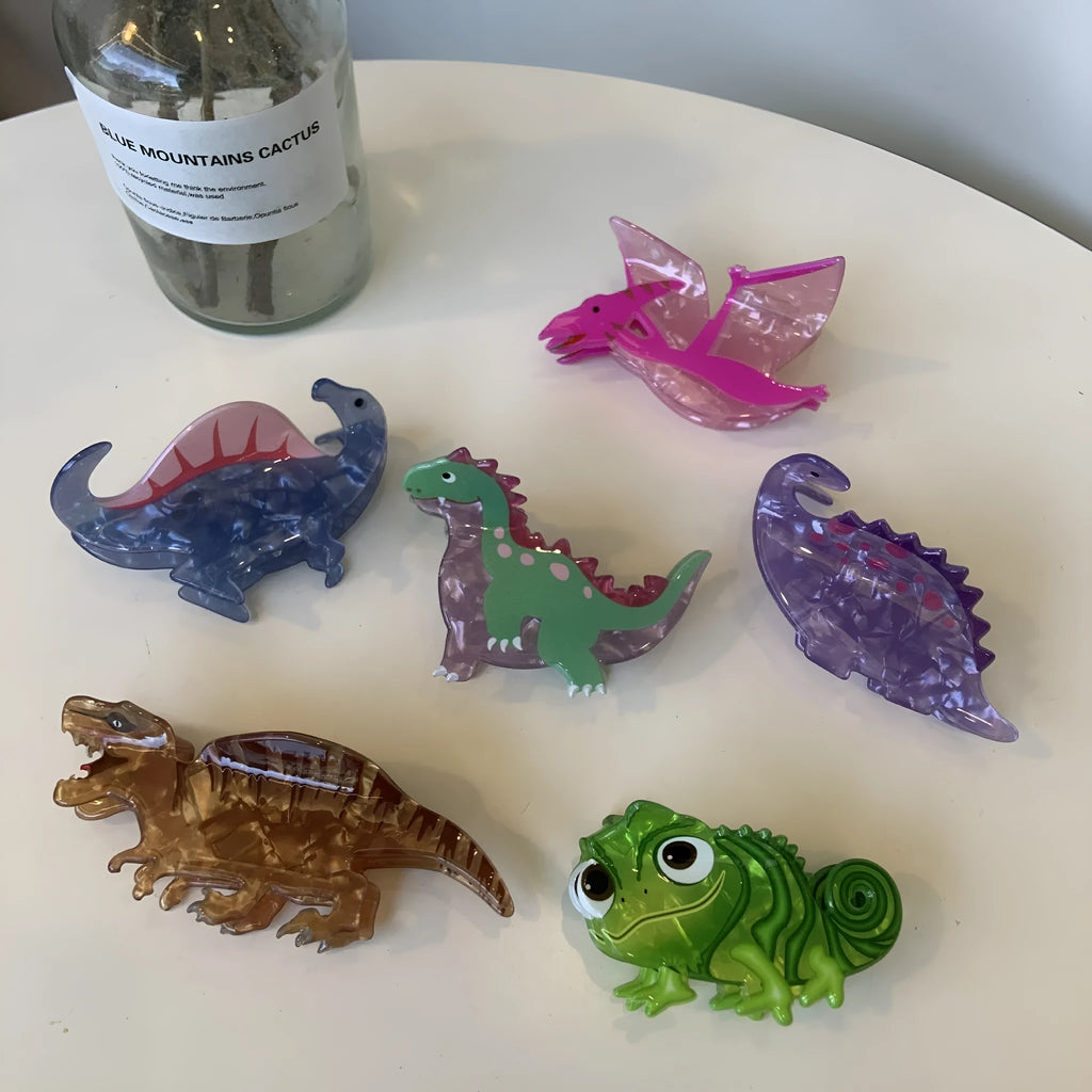Dinosaur-themed acrylic jaw hair clip showing detailed dinosaur design and secure grip mechanism