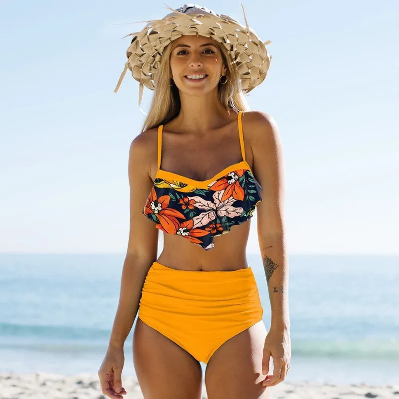 Women's green floral swimsuit set with high-waisted pleated pants and matching top for swimming activities