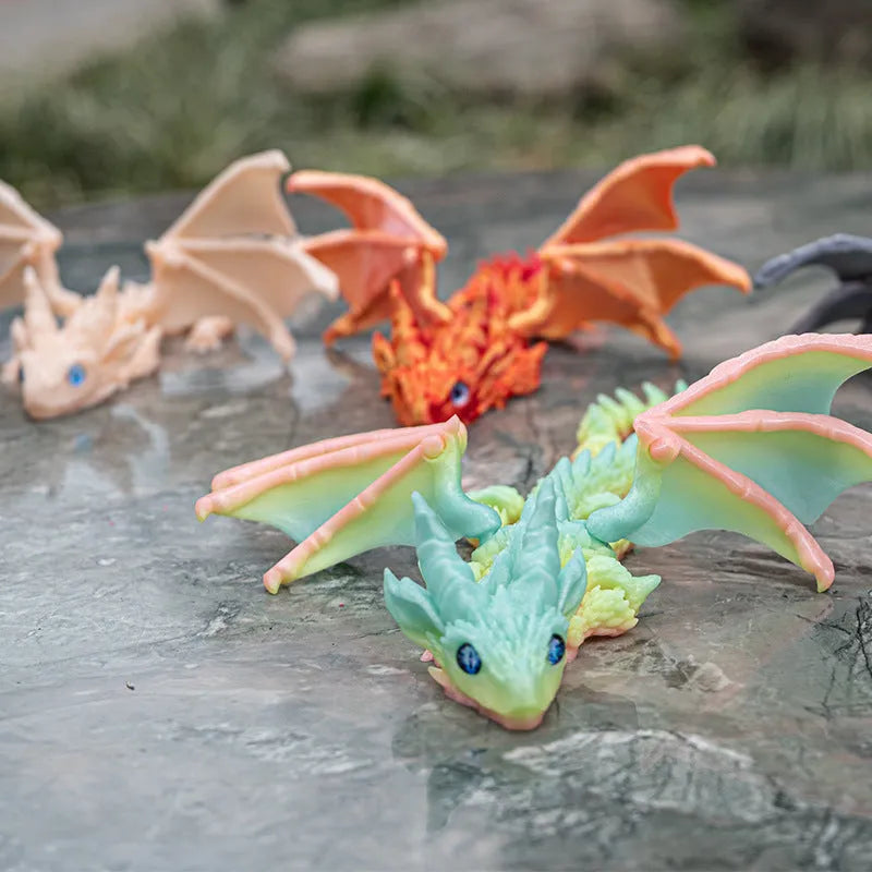 3D printed red and gold flying dragon wings decoration toy on a white background.