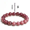 Natural cherry red strawberry quartz bracelet with geometry-shaped beads on a wrist.