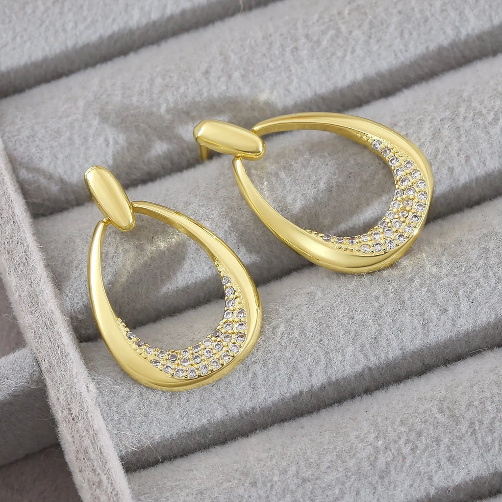 Yellow gold geometric drop earrings with ring design measuring 2.6 by 1.7 centimetres