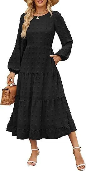 A woman wearing a beige high waist long sleeve dress with ruffled sleeves, a round neck, and a solid colour design.