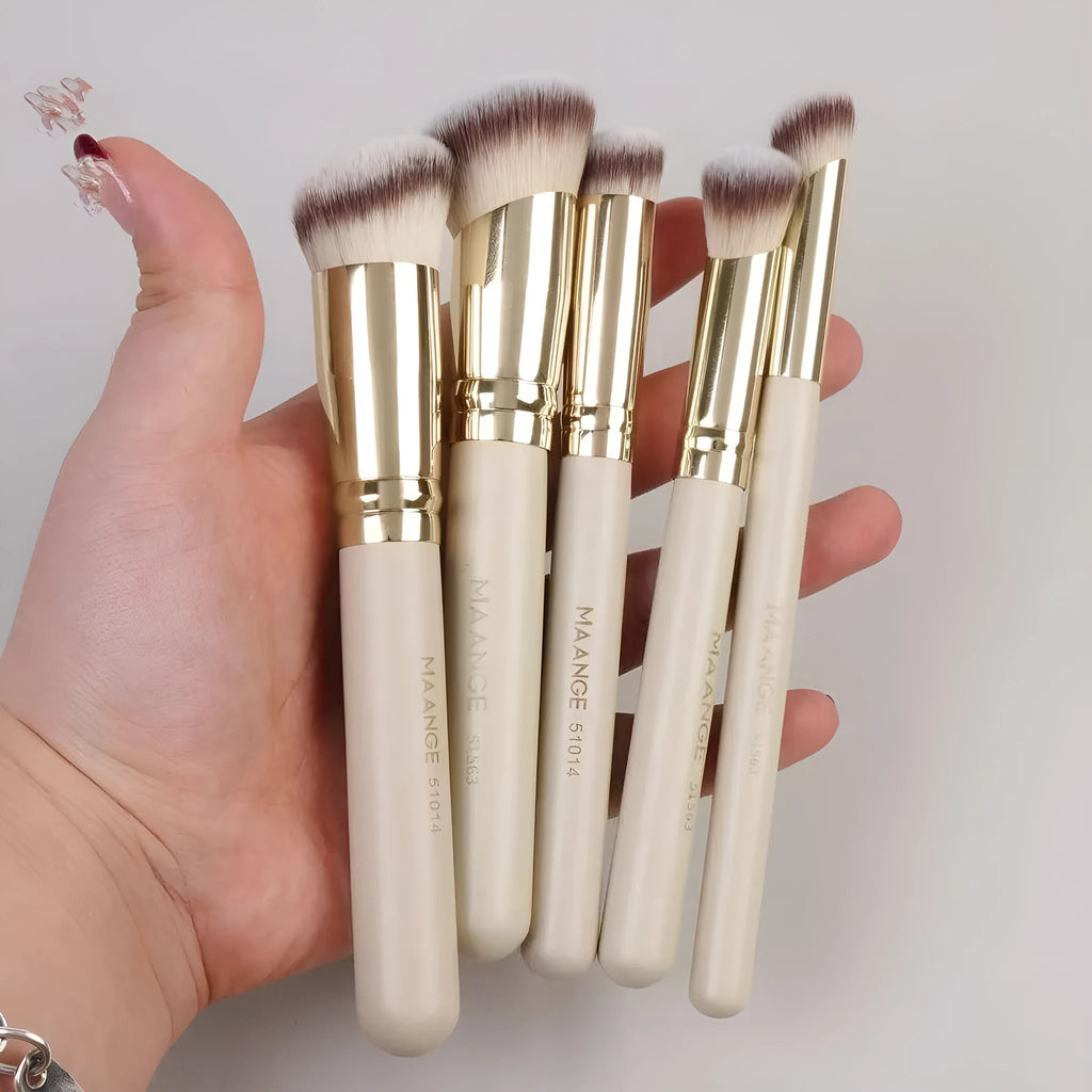 Five apricot coloured makeup brushes with angled blush brush design on white background