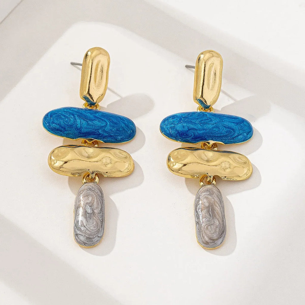 A pair of simple geometric stud earrings with a multicolour electroplated finish on a zinc alloy base.