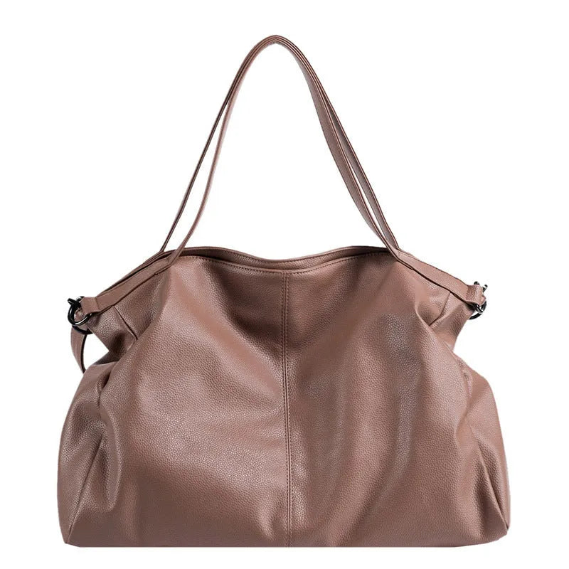 Large horizontal square soft-surface PU leather messenger bag with a long shoulder strap and zip opening.