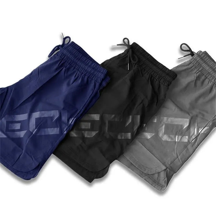 Men's elastic knee-length training shorts in quick-drying chemical blend fabric shown in black colour