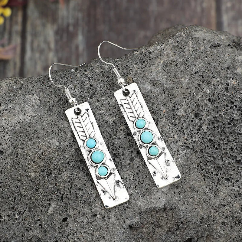 Silver geometric earrings with a long strip design and a blue turquoise inlay