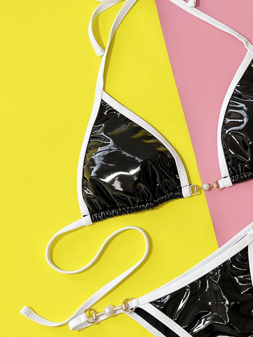 Black solid colour women's split bikini swimsuit set with bra and briefs.