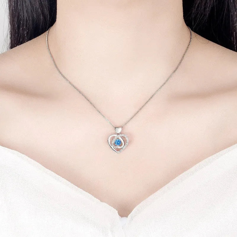 Blue heart-shaped necklace and bracelet set with mixed gem inlay on geometric pendant