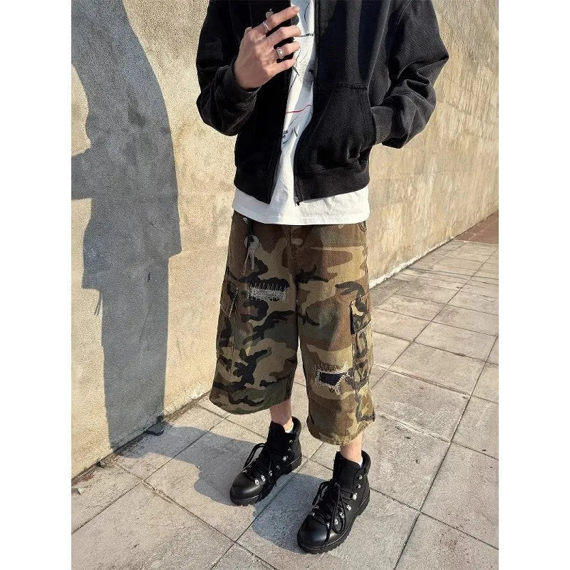 Men's loose-fit camouflage cropped jeans with ripped knee detailing, shown in a straight-leg silhouette.
