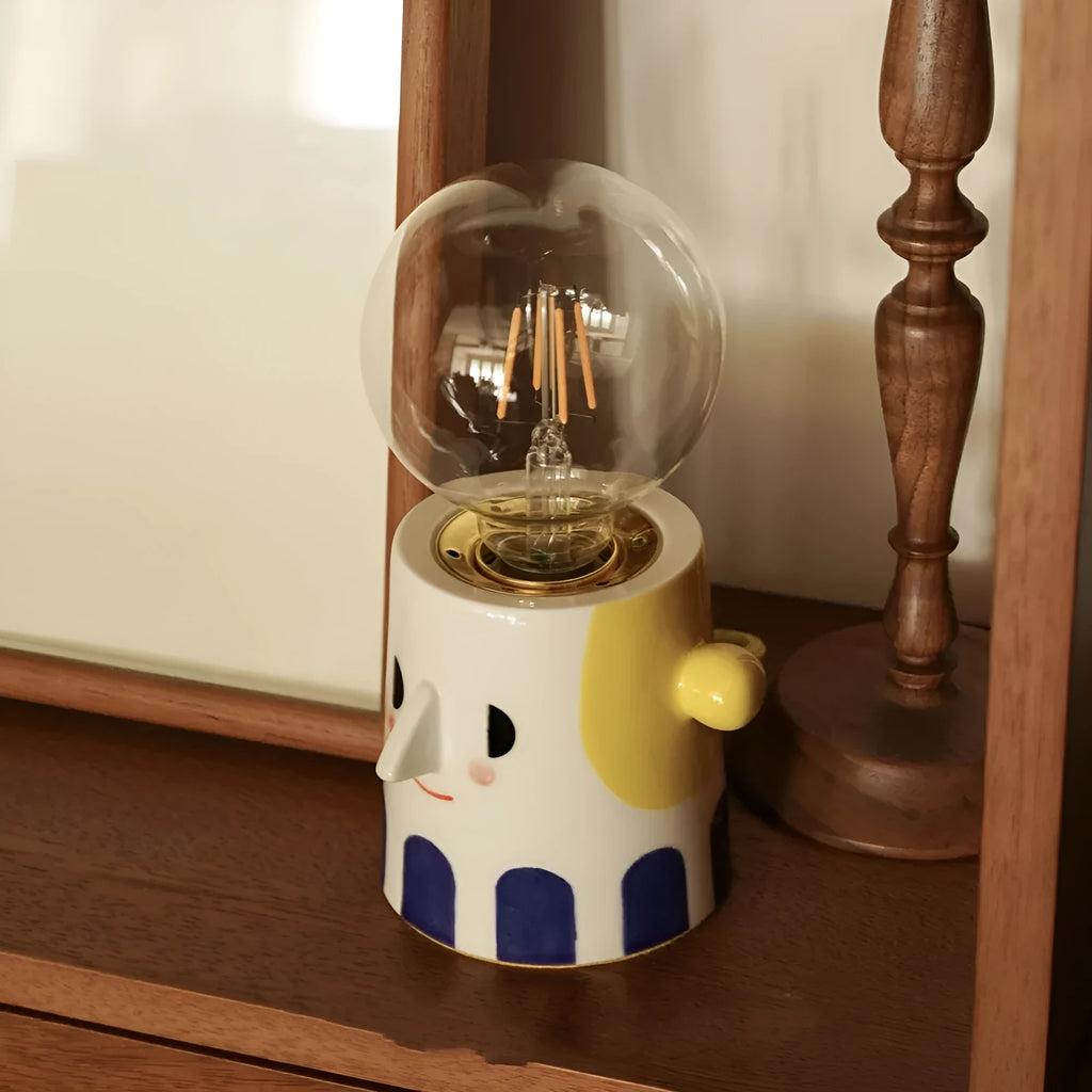 Handmade ceramic bedside lamp with ball headlight shade on wooden surface