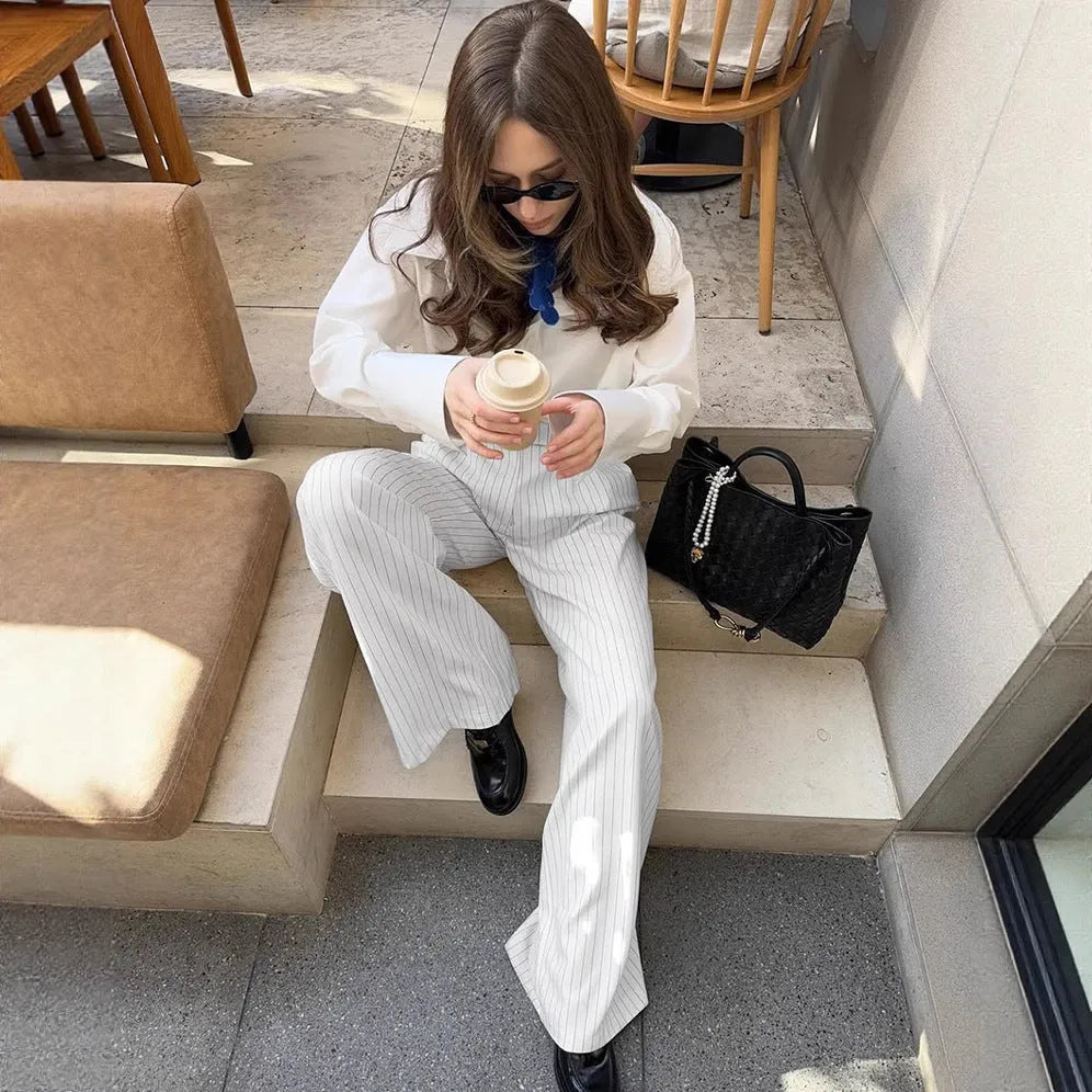 White striped wide-leg loose fit women's trousers with a zip fastening on a mannequin