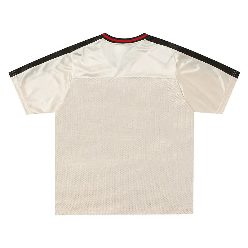 Apricot coloured loose fit V-neck short sleeve pullover top with drop-shoulder sleeves on a hanger.