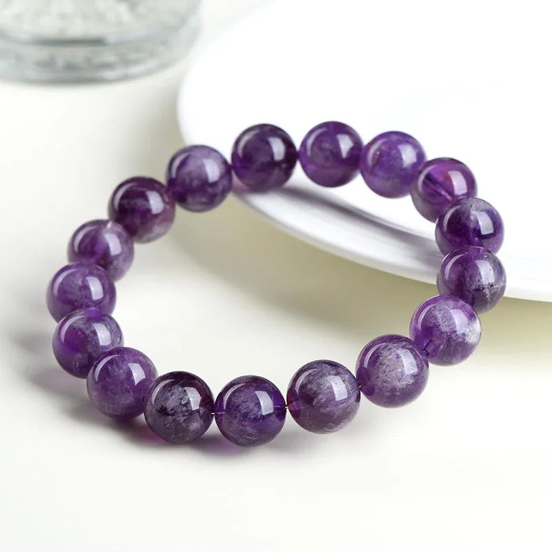 Natural feather amethyst bracelet with purple scattered beads and Ruyi design element.